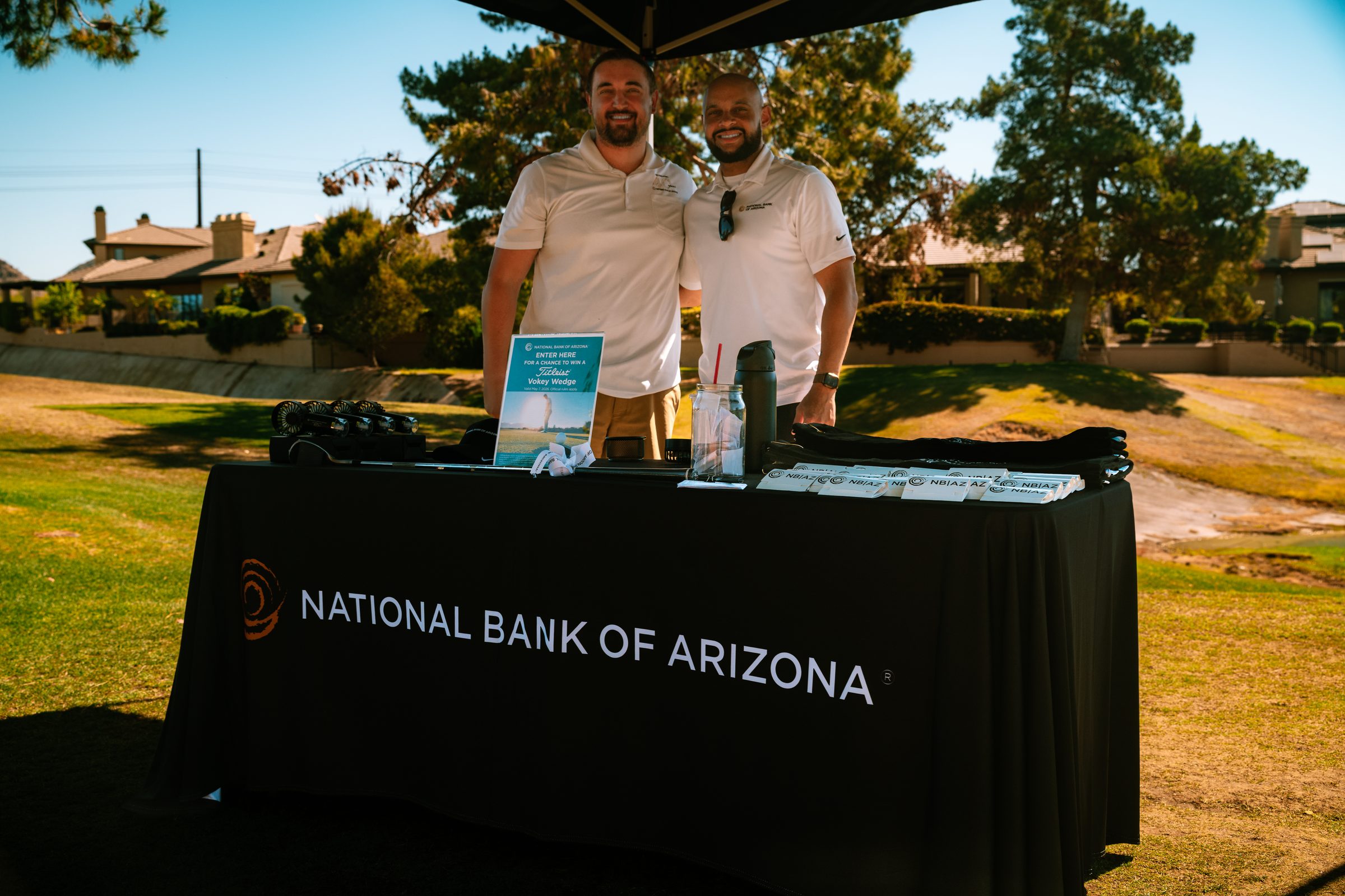 Two National Bank of Arizona sponsors at their table on the course at the Treasure House golf classic
